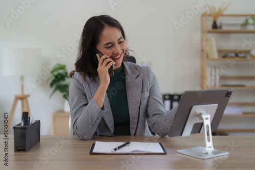 Asian Business woman working at home office and analyze financial report document. Accounting and Finance concept.