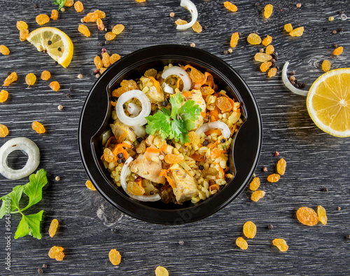 A dish in a black disposable container from catering on a concrete background, dietary catering, ready meals with you, healthy food