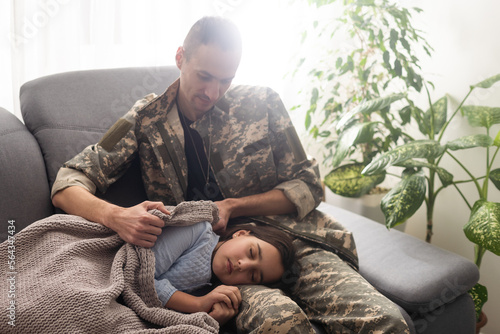 Soldier surprises the sleeping family with his arrival at home. © Angelov