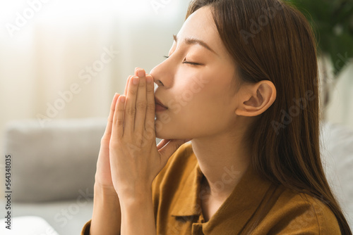 Believe faith charity, calm asian young woman show gratitude, folded hands in prayer feel grateful, meditating with her eyes closed, praying to request God for help. Religious, forgiveness concept.