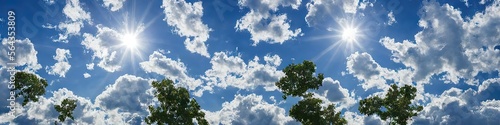 Bright blue skies and fluffy white clouds on a bright and sunny day - A panoramic view of the sky made by generative AI © Brian