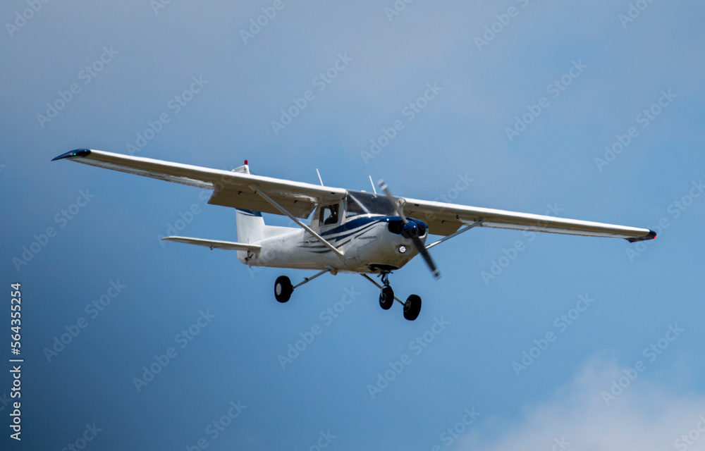 Single prop engine small airplane flying in blue skies Single prop engine small airplane flying in blue skies