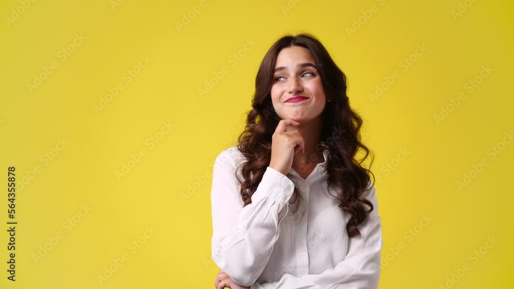 4k slow motion video of girl with cunning facial expression on yellow background. 4k slow motion video of girl with cunning facial expression on yellow background.