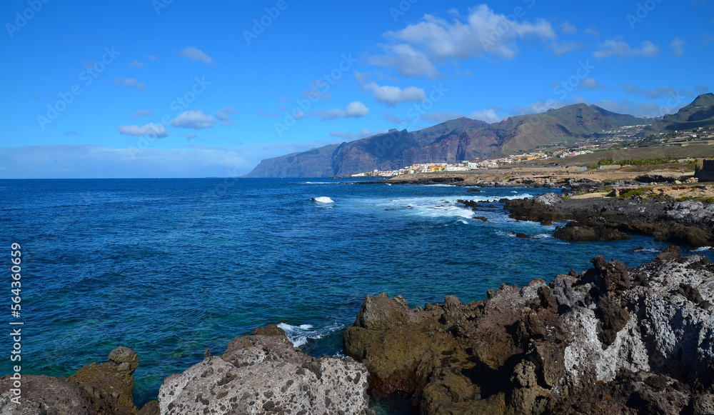 View of the ocean rocky coast and cliffs of Los Gigantes in the distance from Alcala,Tenerife,Canary Islands,Spain.Travel or vacation concept.Selective focus.