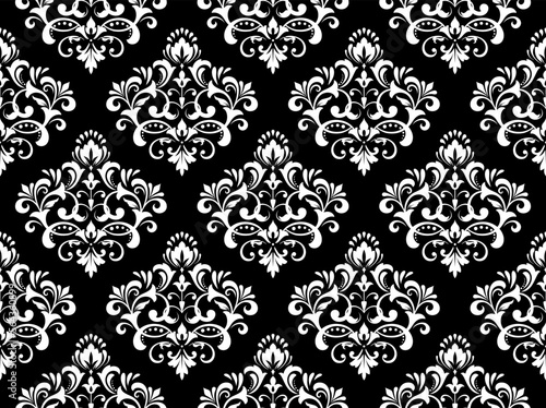 Wallpaper in the style of Baroque. Seamless vector background. White and black floral ornament. Graphic pattern for fabric, wallpaper, packaging. Ornate Damask flower ornament