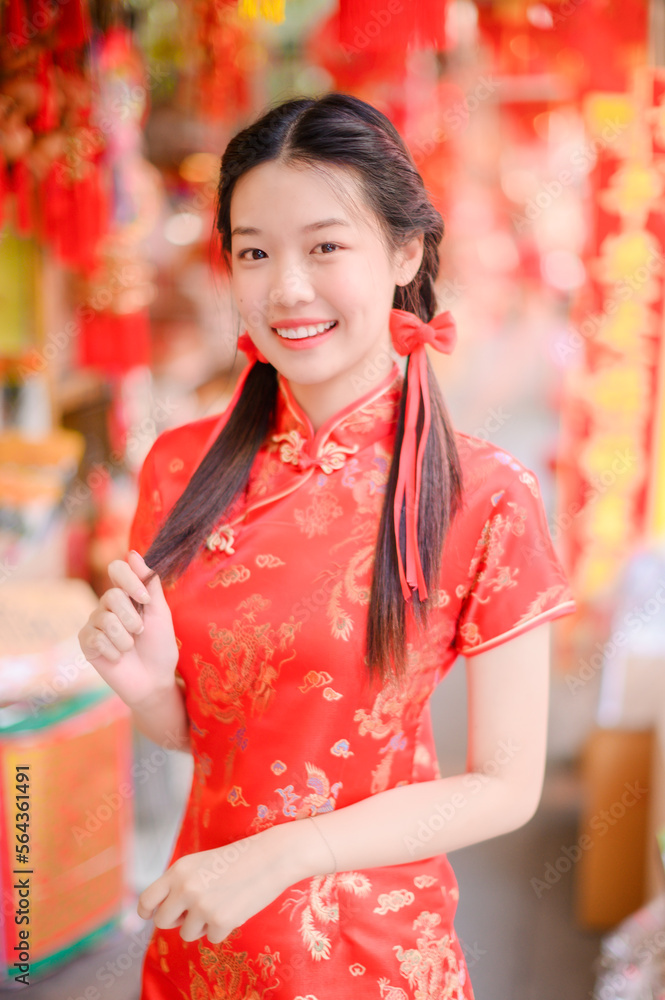 happy asian woman wearing traditional cheongsam qipao dress in Chinese