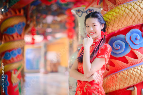 happy asian woman wearing traditional cheongsam qipao dress in Chinese new year day