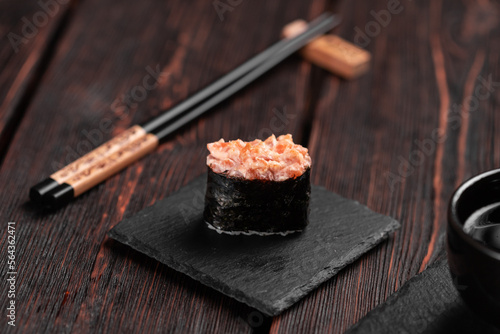 Gunkan Maki Sushi of fish salmon, scallop, perch, eel, shrimp and caviar on wooden table background. Sushi menu. Japanese food sushi set gunkans