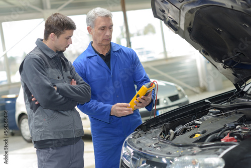 apprentice mechanic working in auto repair shop