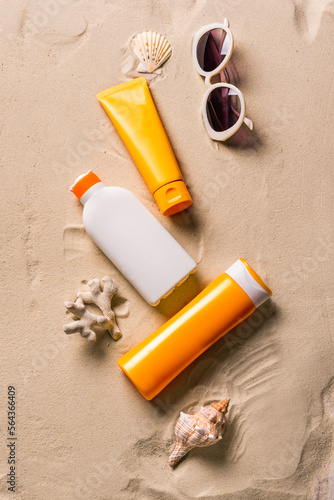 Sunblock lotion bottles and sunglasses