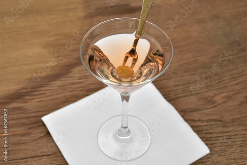 Cuadro en lienzo Wine glass of martini vermouth cocktail with olive.