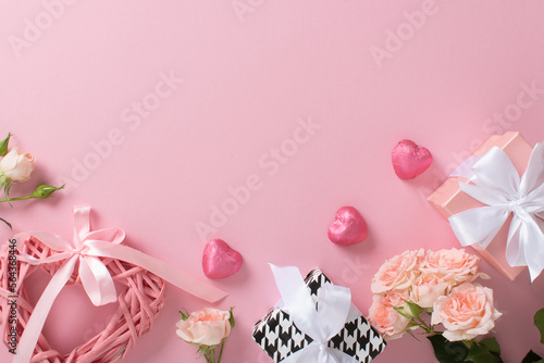 A mock-up of a Valentine's Day banner with a gift box, heart-shaped candies, a braided valentine and a bouquet of roses on a pink background.