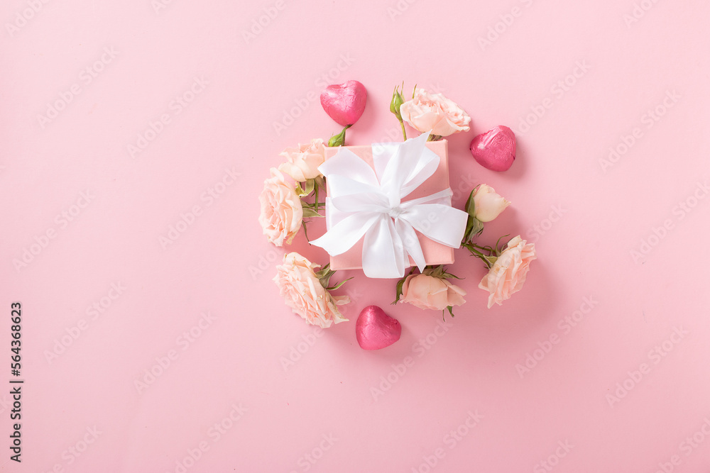 Valentine's Day background. A banner layout with a gift, roses and hearts on a light pink background with a space for text. Valentine's Day background. A banner layout with a gift, roses and hearts on a light pink background with a space for text.