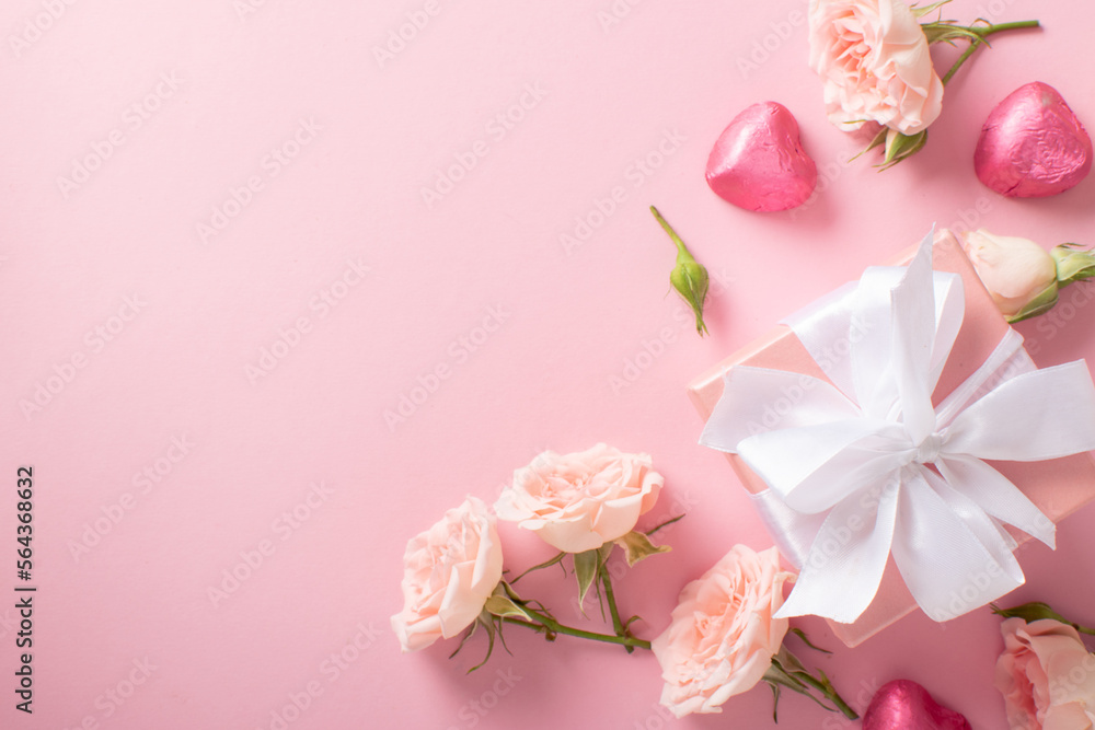 Valentine's Day background. The layout of a postcard with a gift, roses and hearts on a light pink background with a space for text.