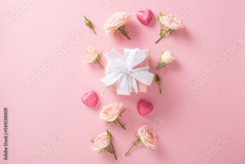 Valentine's Day background. Banner layout with roses and hearts on a light pink background with a space for text. © Irina Lesovaia