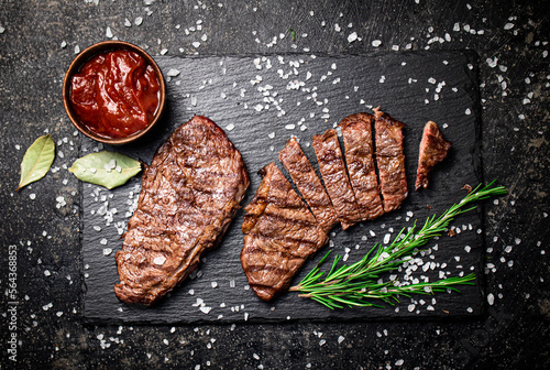 Quadro em tela Grilled steak with a sprig of rosemary.