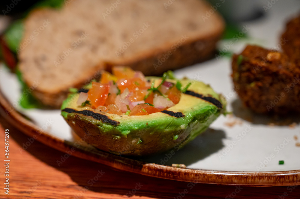 Healthy vegetarian food, vegan falafel balls served with grilles baked eggplant and grilled avocado