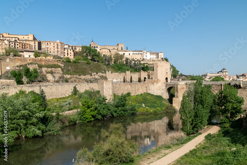 Toledo  Espa  a. April 29  2022 Alcantara Roman Bridge with landscape and blue sky.