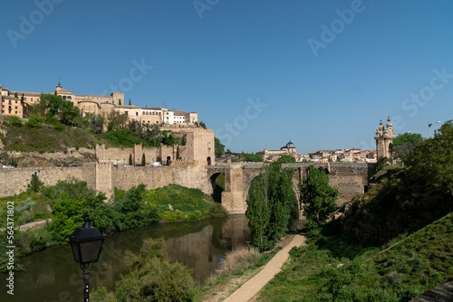 Toledo, España. April 29, 2022:Alcantara Roman Bridge with landscape and blue sky.