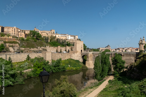Toledo, España. April 29, 2022:Alcantara Roman Bridge with landscape and blue sky.