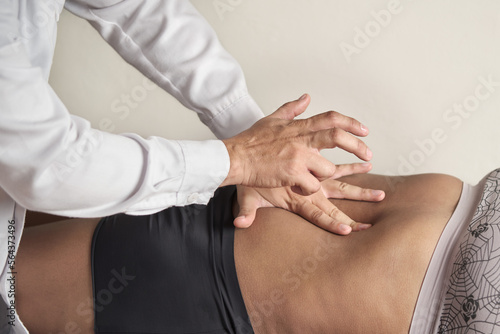 Obraz na plátně doctor's hands piercing abdomen of unrecognizable african american woman
