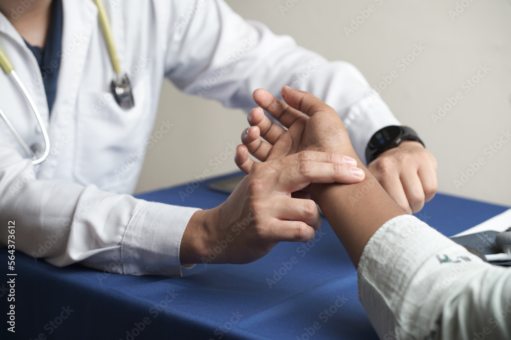 physician with digital watch taking heart rate in radial artery physician with digital watch taking heart rate in radial artery
