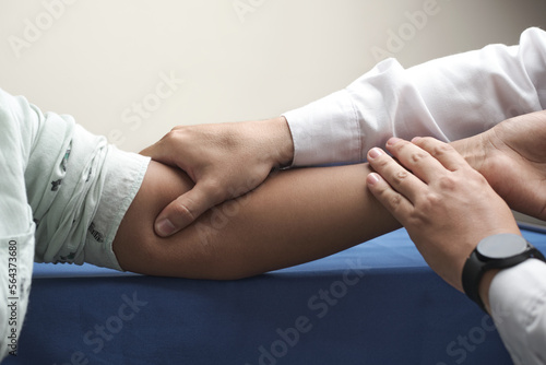 doctor's hands palpating brachial pulse of unrecognizable African-American woman