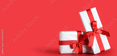 Gift boxes for Valentine's Day on red background with space for text