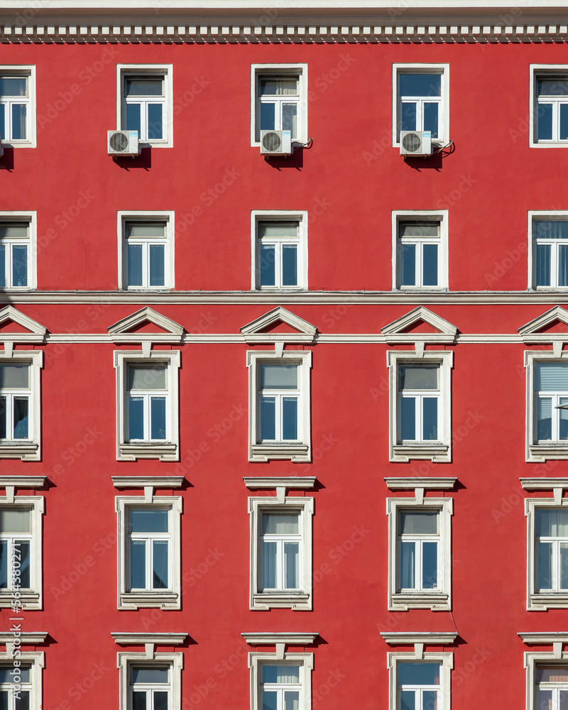 Red painted facade of a classical building