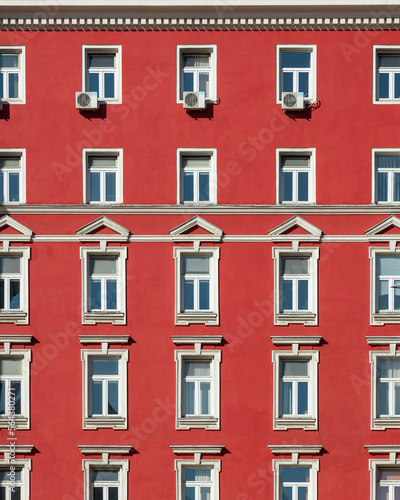 Red painted facade of a classical building