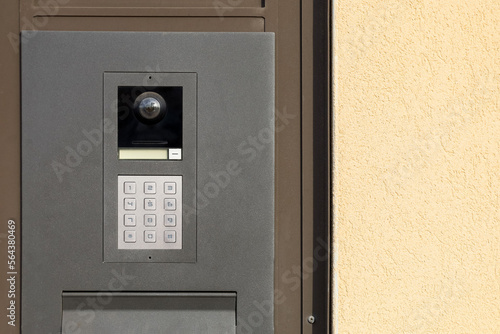 Modern intercom on door outdoors, closeup photo