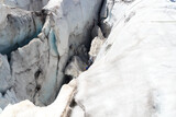 Man is ice climbing in a crevasse of glacier Pasterze at icefall Hufeisenbruch in Glockner Group, Austria