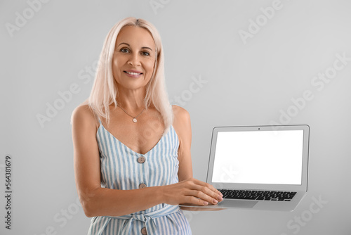 Mature blonde woman with la...