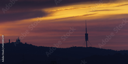 sunrise over the Collserola mountain range with the Barcelona skyline.