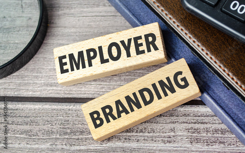 employer branding. text on wooden blocks on wooden background with office supplies