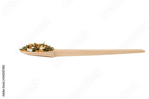 Green tea Japanese Genmaicha. Green tea mixed with roasted popped brown rice on wooden spoon isolated on white background.