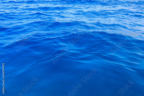 Very nice sea water background or backdrop with selective focus. Small waves of natural water surface texture.