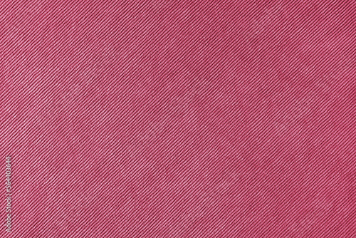 Texture background of velours magenta fabric. Upholstery velveteen texture fabric, corduroy furniture textile material, design interior, decor. Ridge fabric texture close up, backdrop, wallpaper.