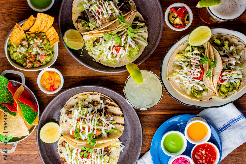 Tacos. Crispy flour and corn tortillas filled with sausage, bacon, beef, cheese, sour cream, salsa and guacamole and served with rice and beans. Classic Tex-Mex or Mexican restaurant entrée favorite. Tacos. Crispy flour and corn tortillas filled with sausage, bacon, beef, cheese, sour cream, salsa and guacamole and served with rice and beans. Classic Tex-Mex or Mexican restaurant entrée favorite.
