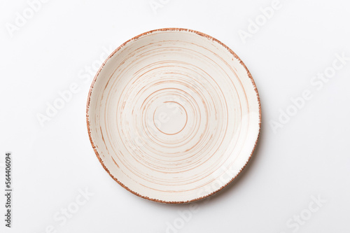 Fototapeta Naklejka Na Ścianę i Meble -  Top view of isolated of colored background empty round beige plate for food. Empty dish with space for your design