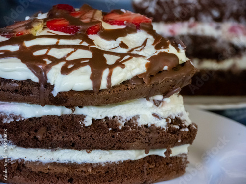 Sweet and delicious chocolate cake with whipped cream and strawberries and raspberries.