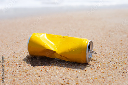 Yellow can waste on the beach