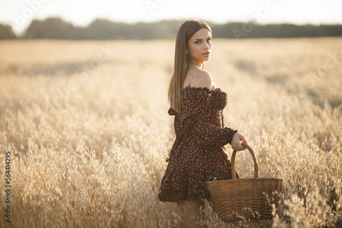 Wallpaper Mural young caucasian female harvests in a field with a basket Torontodigital.ca