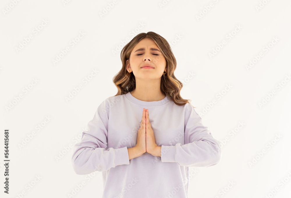 Smiling attractive charming caucasian woman holding palms together pray, smiling friendly showing namaste welcome gesture, inviting guests come in