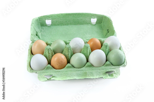 Eggs with different shell colors in a cardboard package on a white background photo