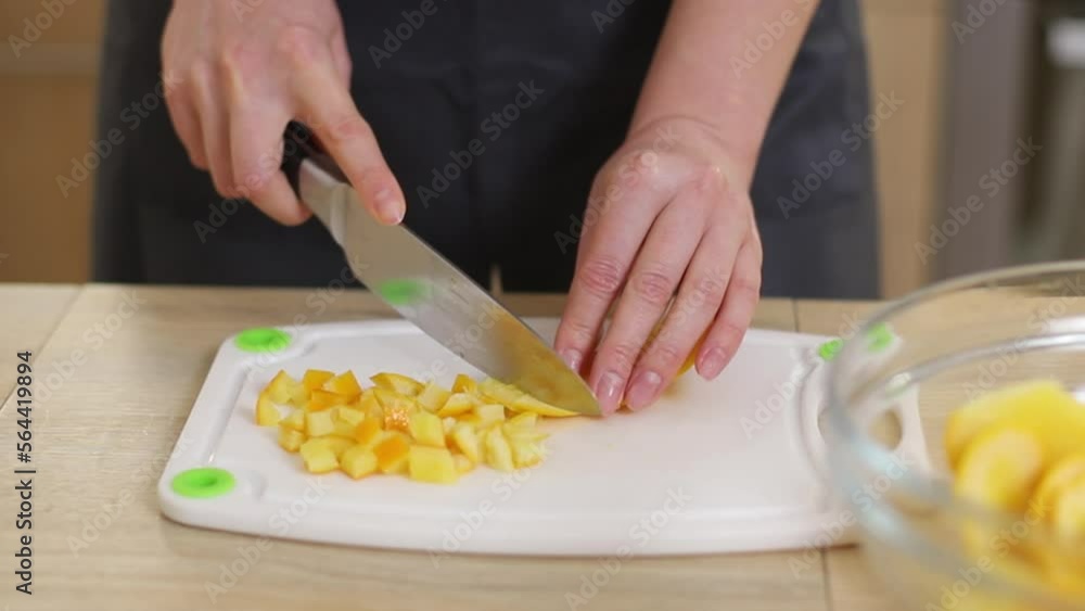 Preparation of candied oranges. A pastry chef with a white tunic peels and cuts an orange against the background of a beige kitchen
Preparation of candied oranges. A pastry chef with a white tunic peels and cuts an orange against the background of a beige kitchen