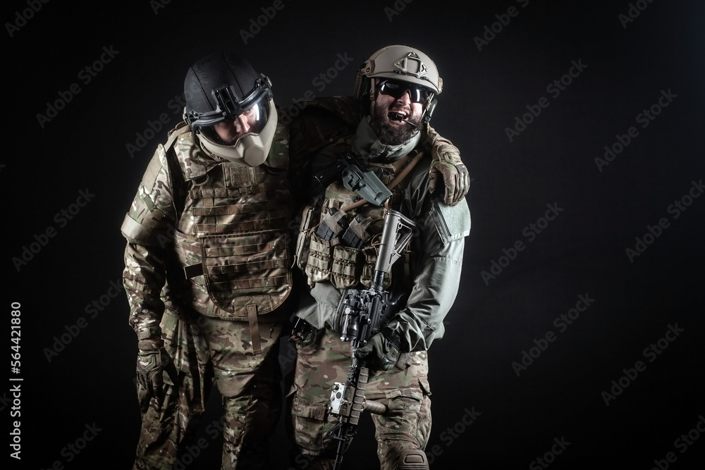 commando rescues a wounded soldier in a special operation, a ranger in military uniform with a weapon commando rescues a wounded soldier in a special operation, a ranger in military uniform with a weapon