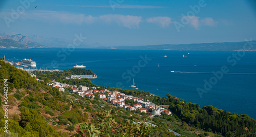 The view of a bay from a hill on the Mediterranean Sea in the town of split as boats and cruise ships enter the harbor