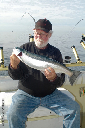 An angler with a steelhead on Lake Michigan 