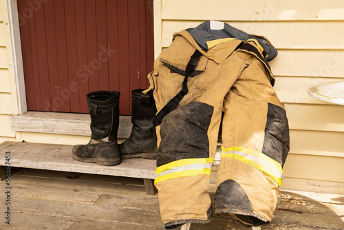 Boots and fireproof overalls used by a volunteer fireman put out to dry.